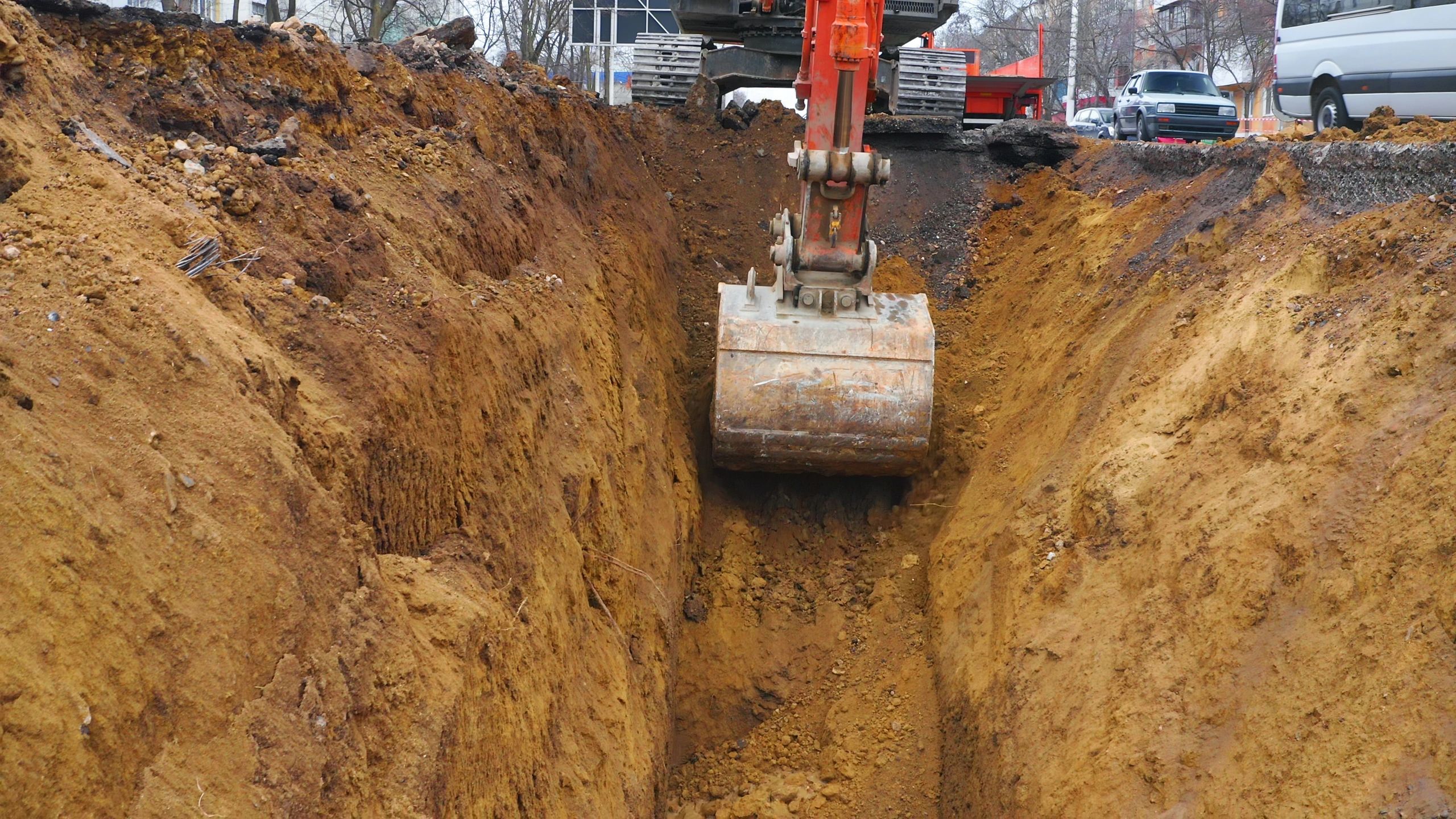 Excavator digging a trench for water line installation
